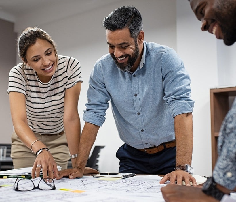 people looking at design blueprints